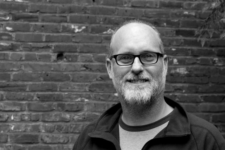 Black and white headshot of Andrew Hedges.