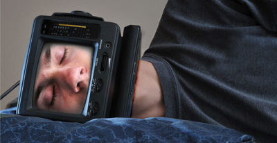 Sleeping man with device surrounding face. Image source:  Sleeping TV Man by Evan is licensed by CC BY-ND 2.0.